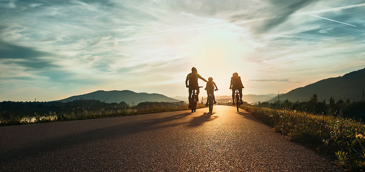 Three people cycling in the countryside
