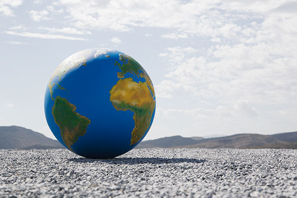 A model globe sits on the ground.