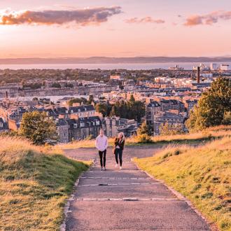 Two people walking up a hill in Edinburgh