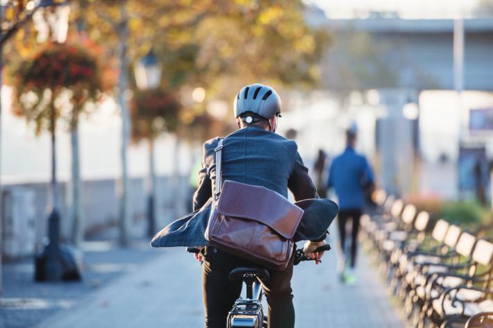 Man in suit cycling to work