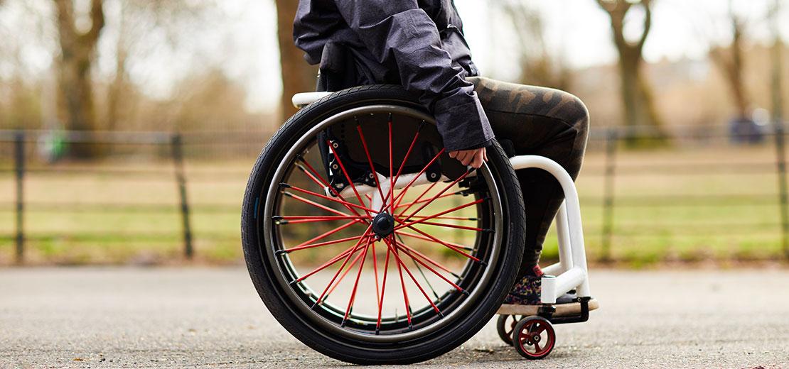 A person in a wheelchair outside.